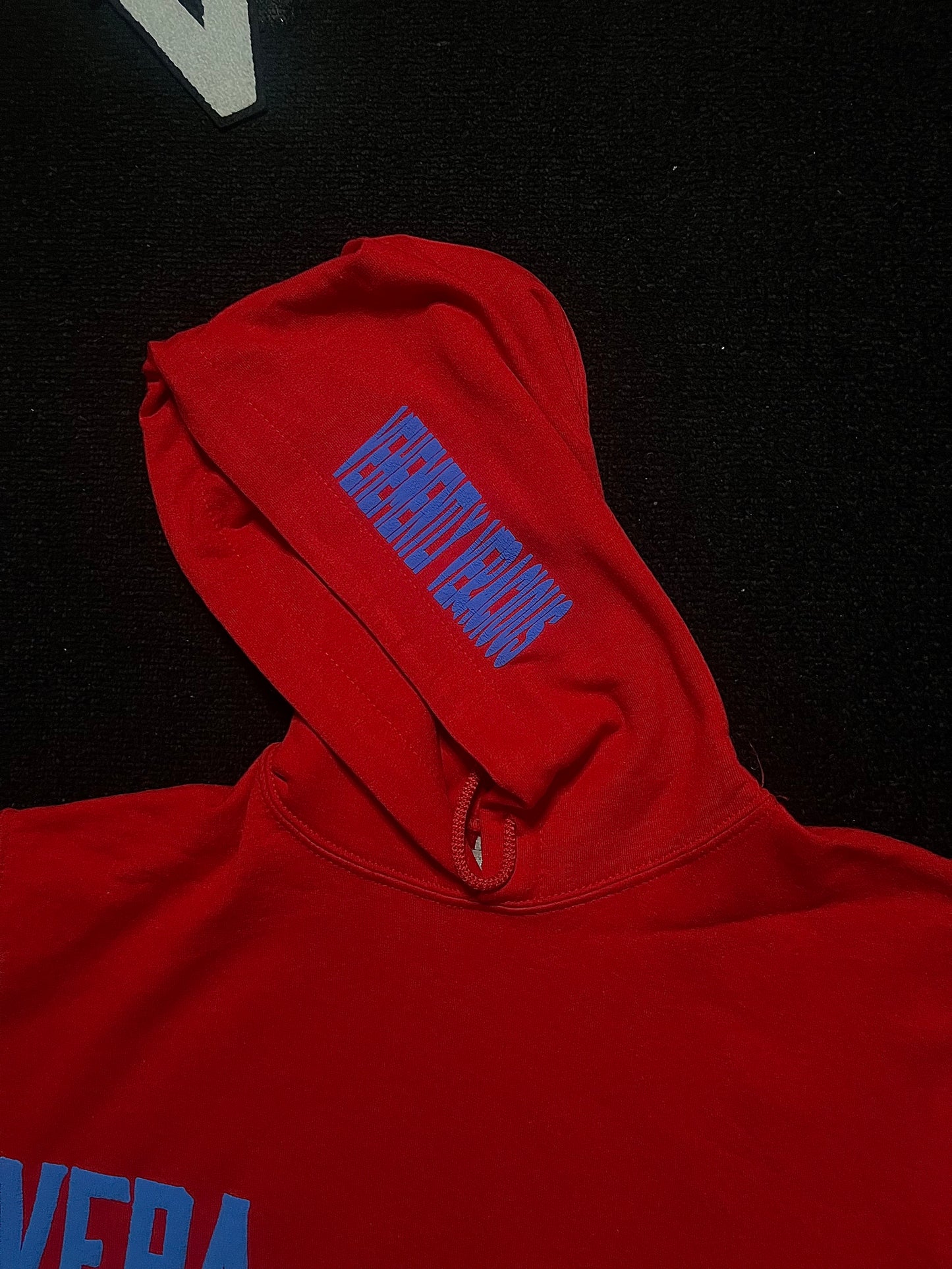 Red hoodie with blue text on a black background