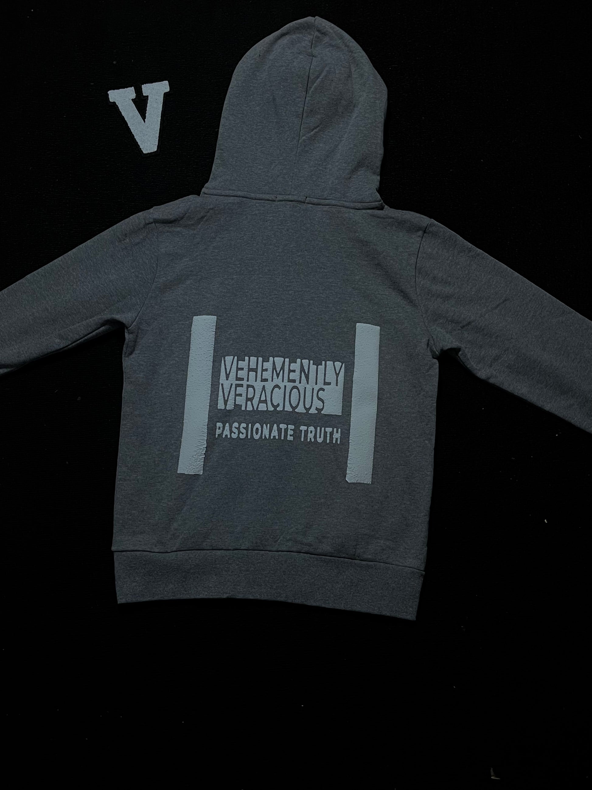 Gray hoodie with text on the back against a black background