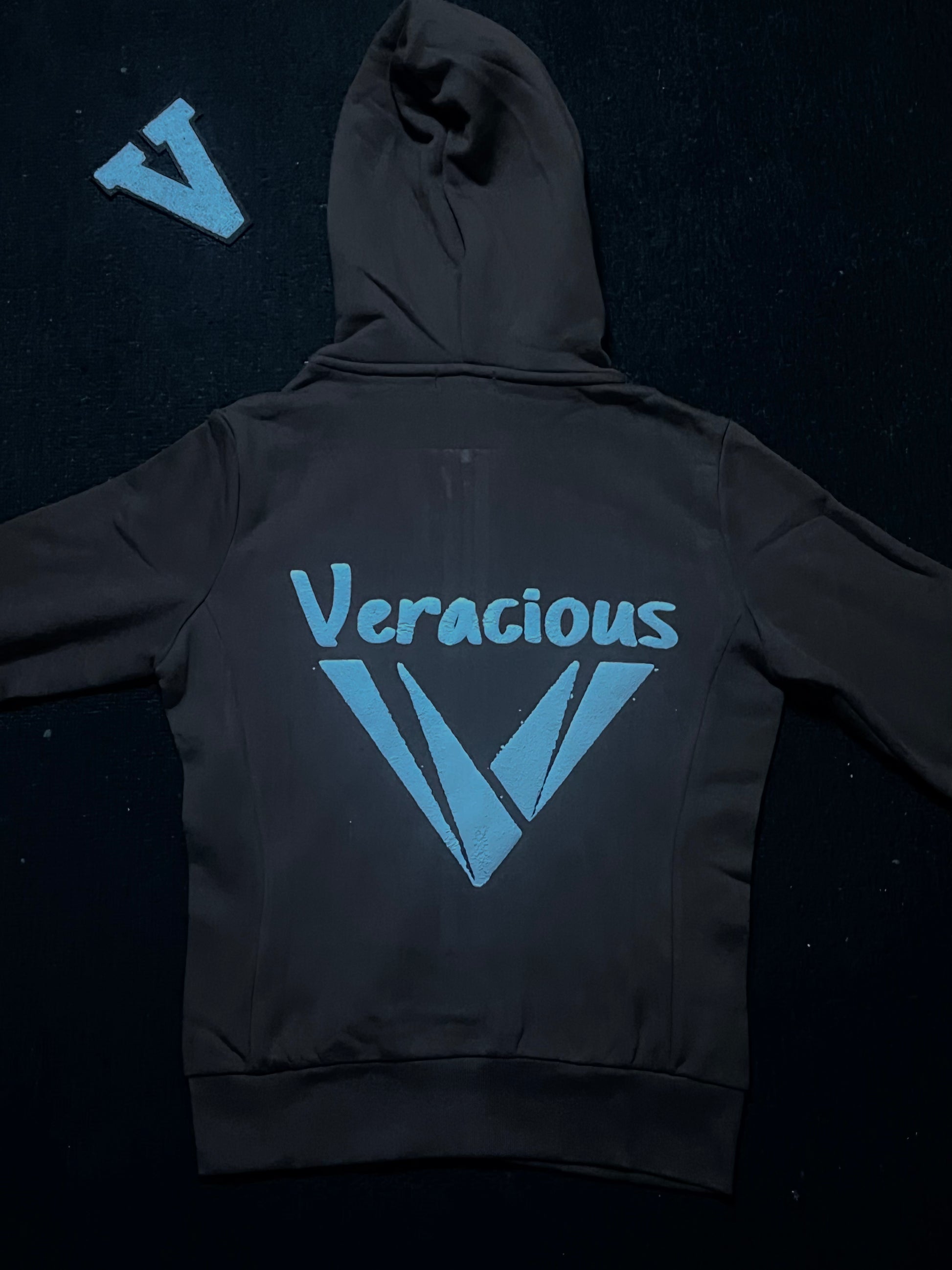 deep chocolate hoodie with 'Veracious' logo on the back against a dark background